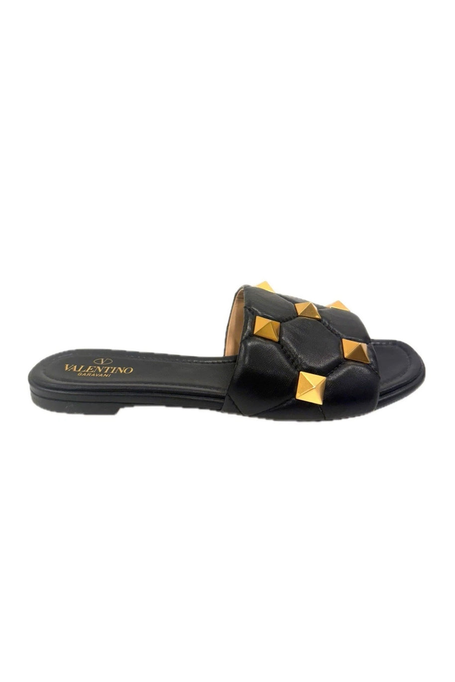Side profile of Valentino Roman Stud black Nappa leather slides with gold-tone stud detailing.