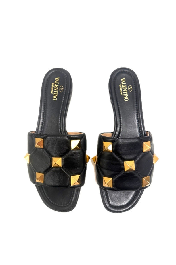 Top view of Valentino Roman Stud Slides in black Nappa leather with gold hardware – size IT 39.
