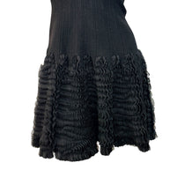 Alaïa black ribbed knit dress sculptural ruffle skirt close-up detail