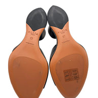 Bottom view of Alaïa La Sculpture black leather mules showing Alaïa Paris branding, EU size 37, Made in Italy markings and leather outsoles with light surface wear.