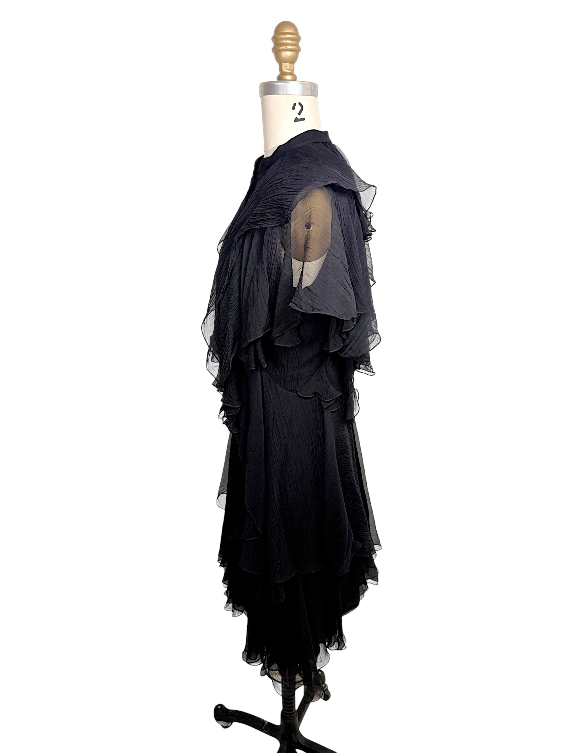 Side profile of the Alexander McQueen Pre-Fall 2016 black silk chiffon dress highlighting layered chiffon construction and cascading ruffle details.