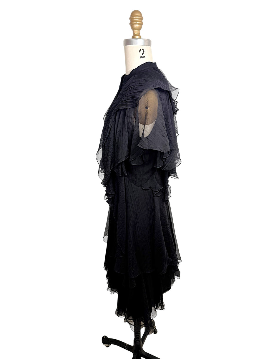 Side profile of the Alexander McQueen Pre-Fall 2016 black silk chiffon dress highlighting layered chiffon construction and cascading ruffle details.