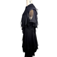 Side profile of the Alexander McQueen Pre-Fall 2016 black silk chiffon dress highlighting layered chiffon construction and cascading ruffle details.