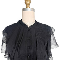 Detailed view of the Alexander McQueen Pre-Fall 2016 dress showing the stand collar, covered silk buttons, pleated silk chiffon, and cascading front ruffles.