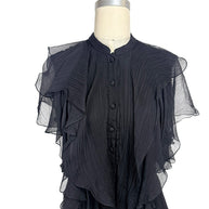 Close-up of the Alexander McQueen Pre-Fall 2016 black silk chiffon dress highlighting the pleated bodice, covered silk buttons, stand collar, and cascading ruffle detailing.