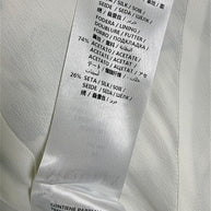 Alexander McQueen Resort 2019 seashell print dress composition label showing 100% silk exterior and acetate silk lining