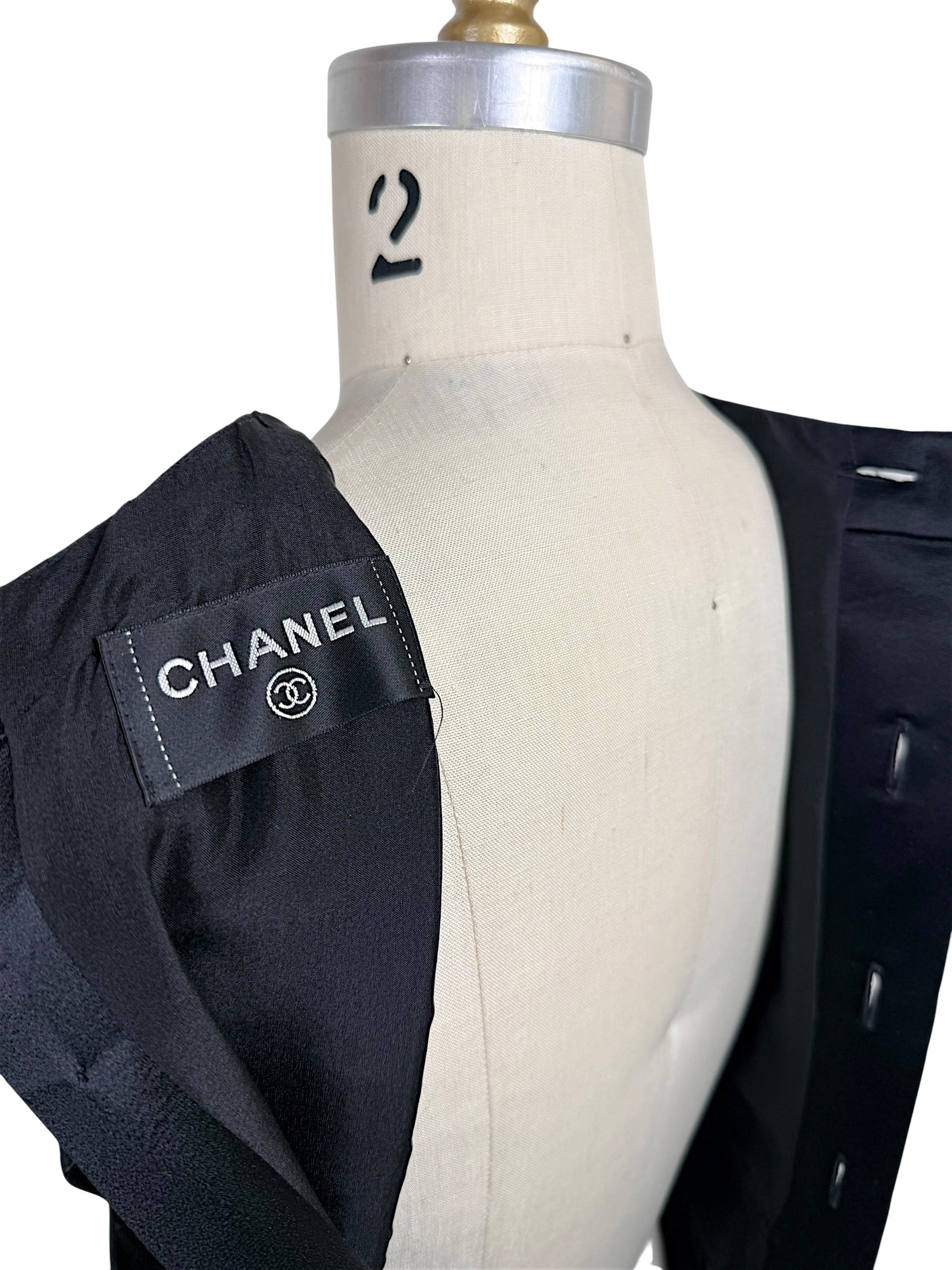 Interior Chanel label detail from authentic vintage black satin pleated dress made in France.