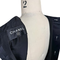 Interior Chanel label detail from authentic vintage black satin pleated dress made in France.