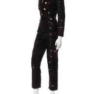 Balmain black sequin pantsuit with signature gold-tone buttons, three-quarter side view