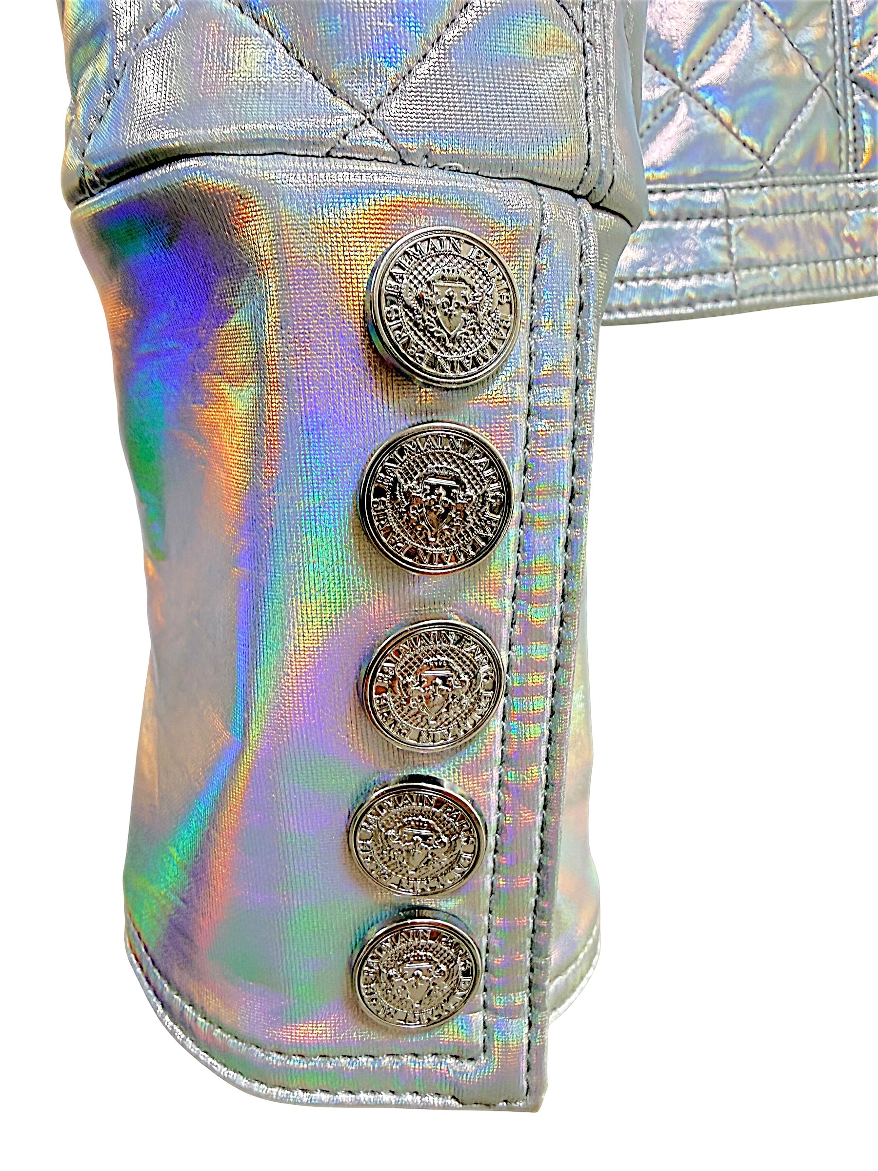 Close-up of Balmain holographic silver jacket cuff with five embossed silver-tone Balmain crest buttons