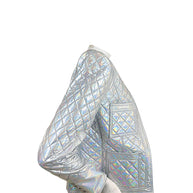 Side view of Balmain Fall 2018 holographic silver quilted runway jacket showing diamond quilting, patch pockets and button cuff