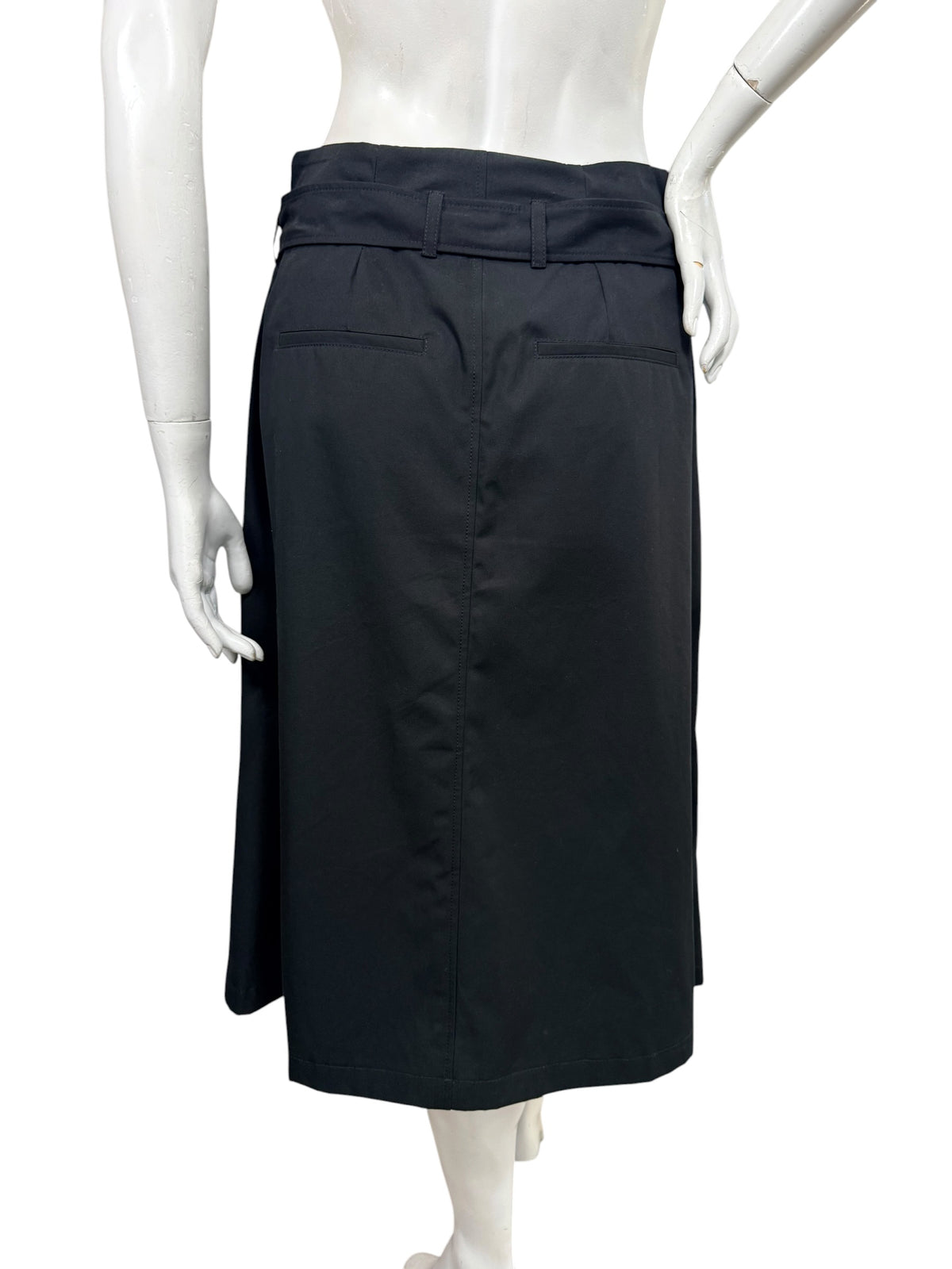 Back view of Celine black cotton midi skirt showing matching waist belt, rear welt pockets, center seam, and straight hemline.