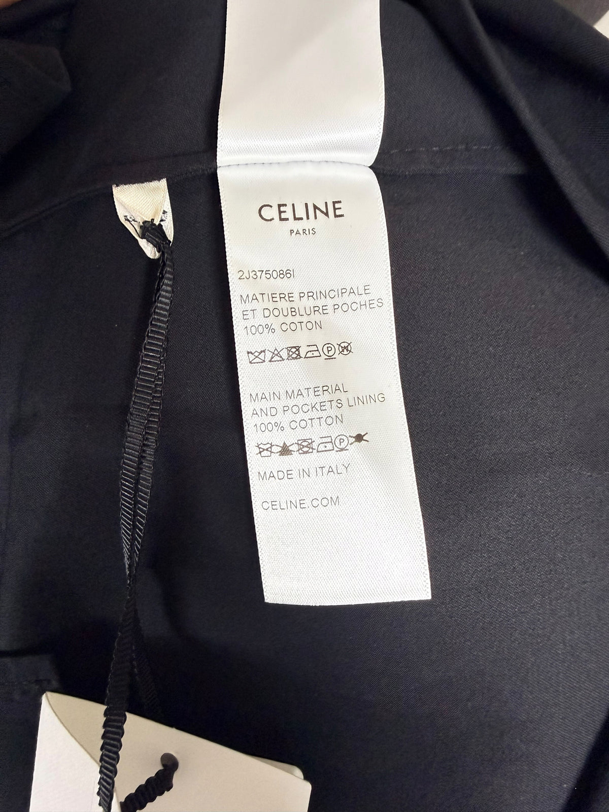 Celine Paris black midi skirt interior composition and care label confirming 100% cotton main fabric and pocket lining, made in Italy.