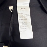 Celine Paris black midi skirt interior composition and care label confirming 100% cotton main fabric and pocket lining, made in Italy.