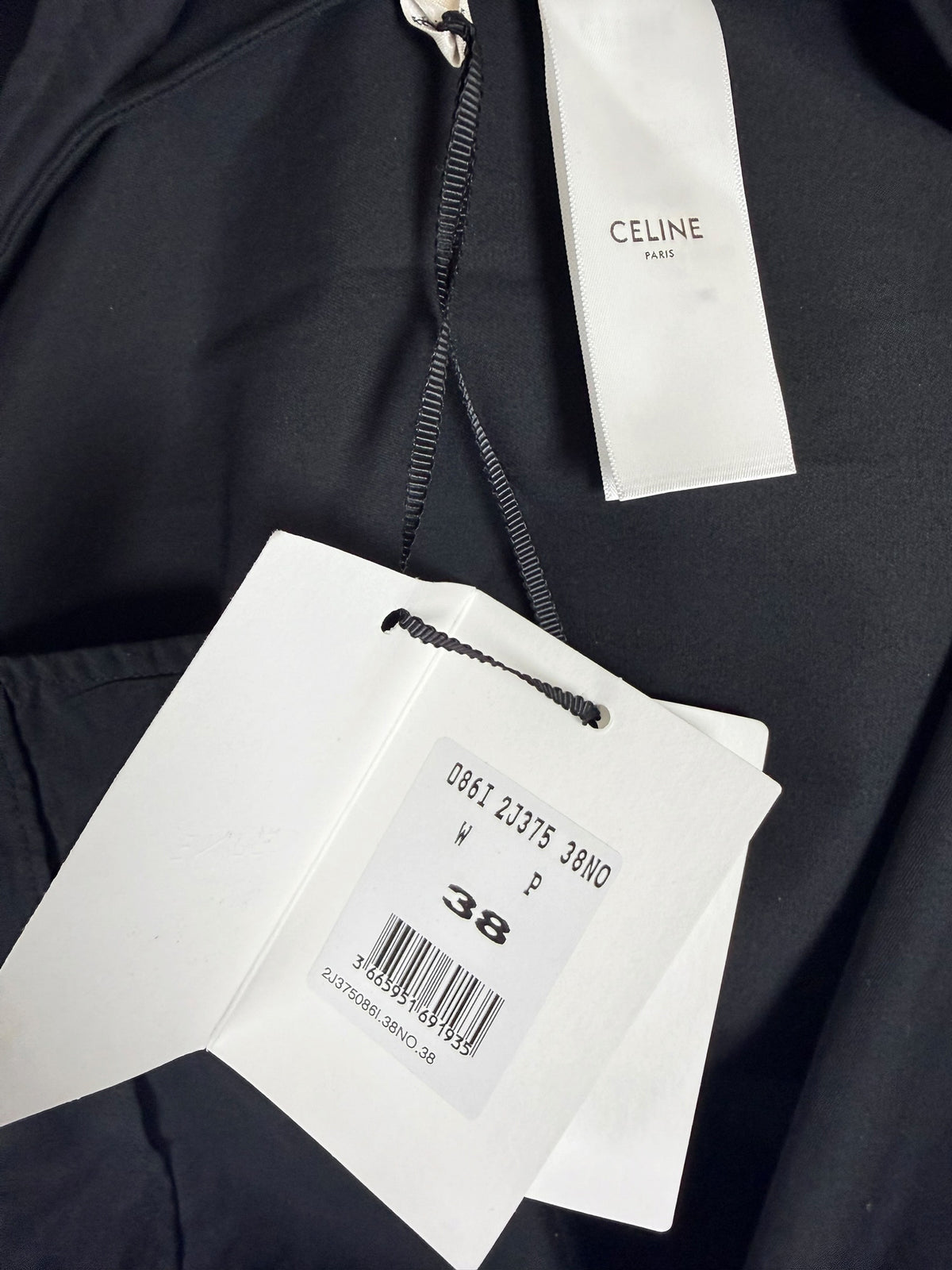 Celine black cotton belted midi skirt original retail hangtag showing style reference 2J375086I, size FR 38, and Celine Paris label.