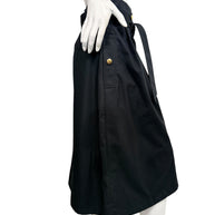 Side profile of Celine black cotton belted midi skirt showing gold-tone button pocket detail and below-the-knee silhouette.