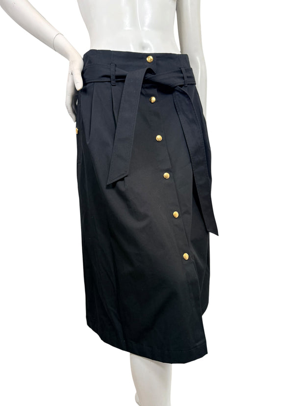 Angled front view of Celine black cotton midi skirt featuring gold-tone buttons, high waist, and coordinating fabric tie belt.