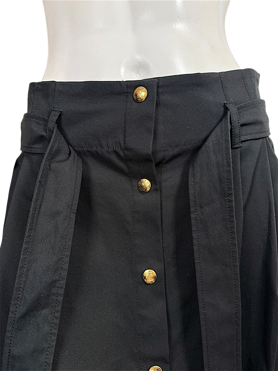 Close-up of Celine black cotton skirt high waistband, matching tie belt, belt loops, and decorative gold-tone Triomphe buttons.