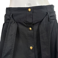 Close-up of Celine black cotton skirt high waistband, matching tie belt, belt loops, and decorative gold-tone Triomphe buttons.
