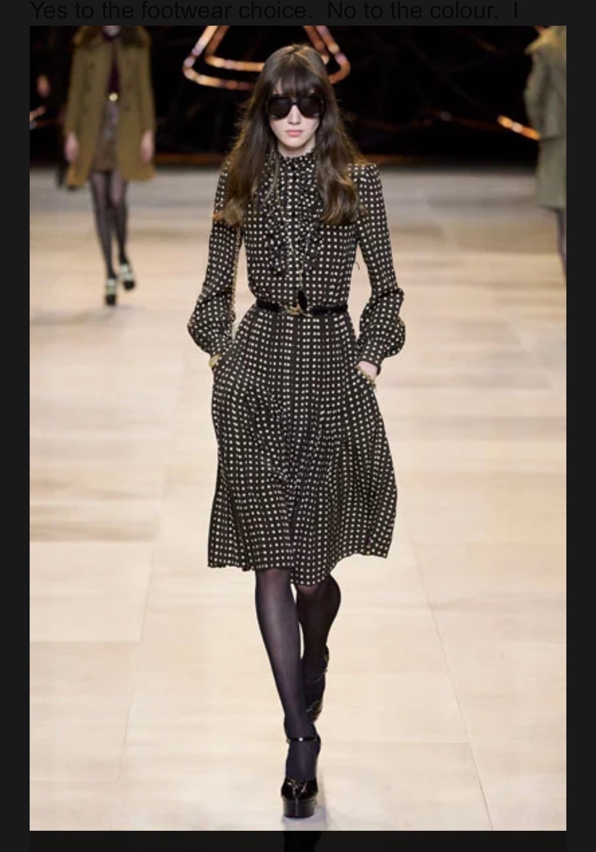 Celine Fall Winter 2020 runway Look 15 featuring a brown polka dot high-neck silk midi dress with ruffled front, long sleeves and pleated skirt.