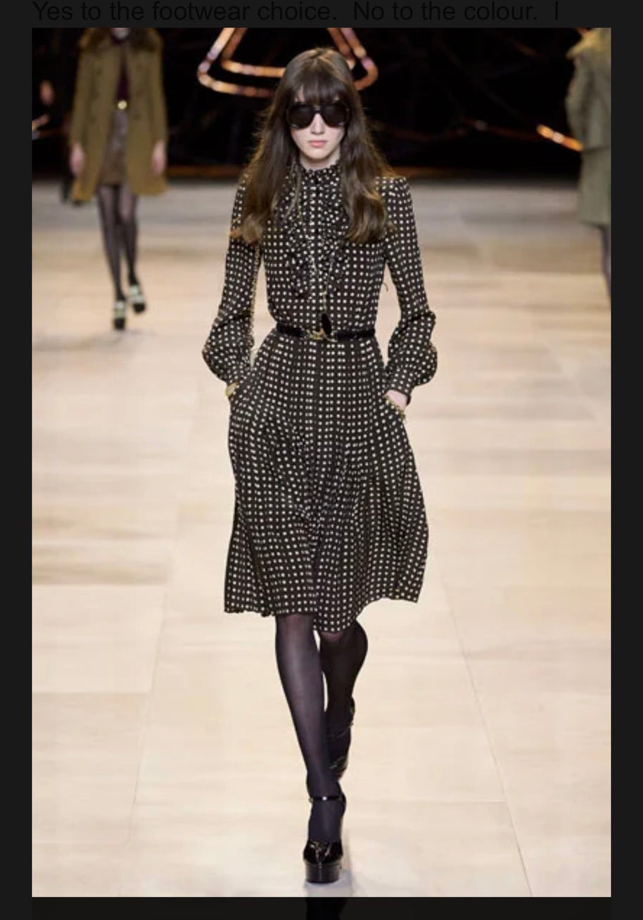 Celine Fall Winter 2020 runway Look 15 featuring a brown polka dot high-neck silk midi dress with ruffled front, long sleeves and pleated skirt.
