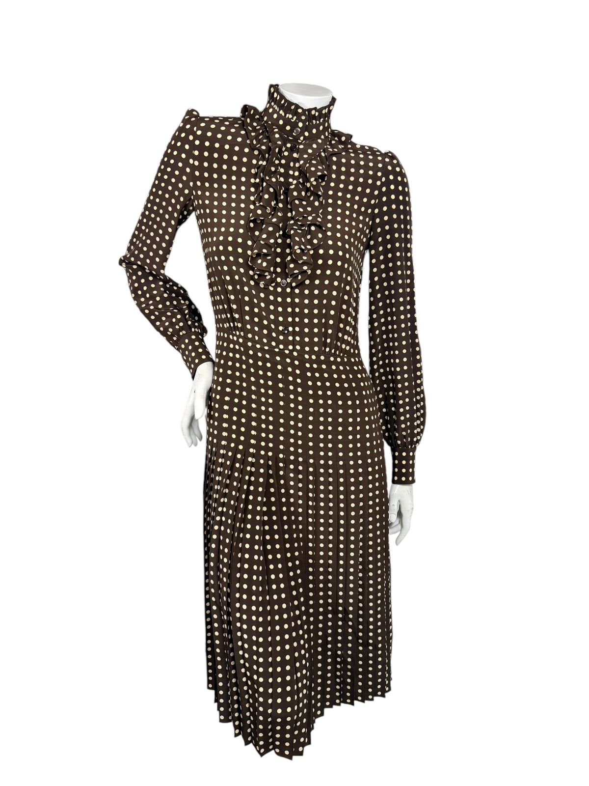 Celine Fall Winter 2020 Runway Look 15 brown polka dot silk dress with fastened high ruffled collar, long sleeves and pleated midi skirt.