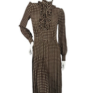 Celine Fall Winter 2020 Runway Look 15 brown polka dot silk dress with fastened high ruffled collar, long sleeves and pleated midi skirt.