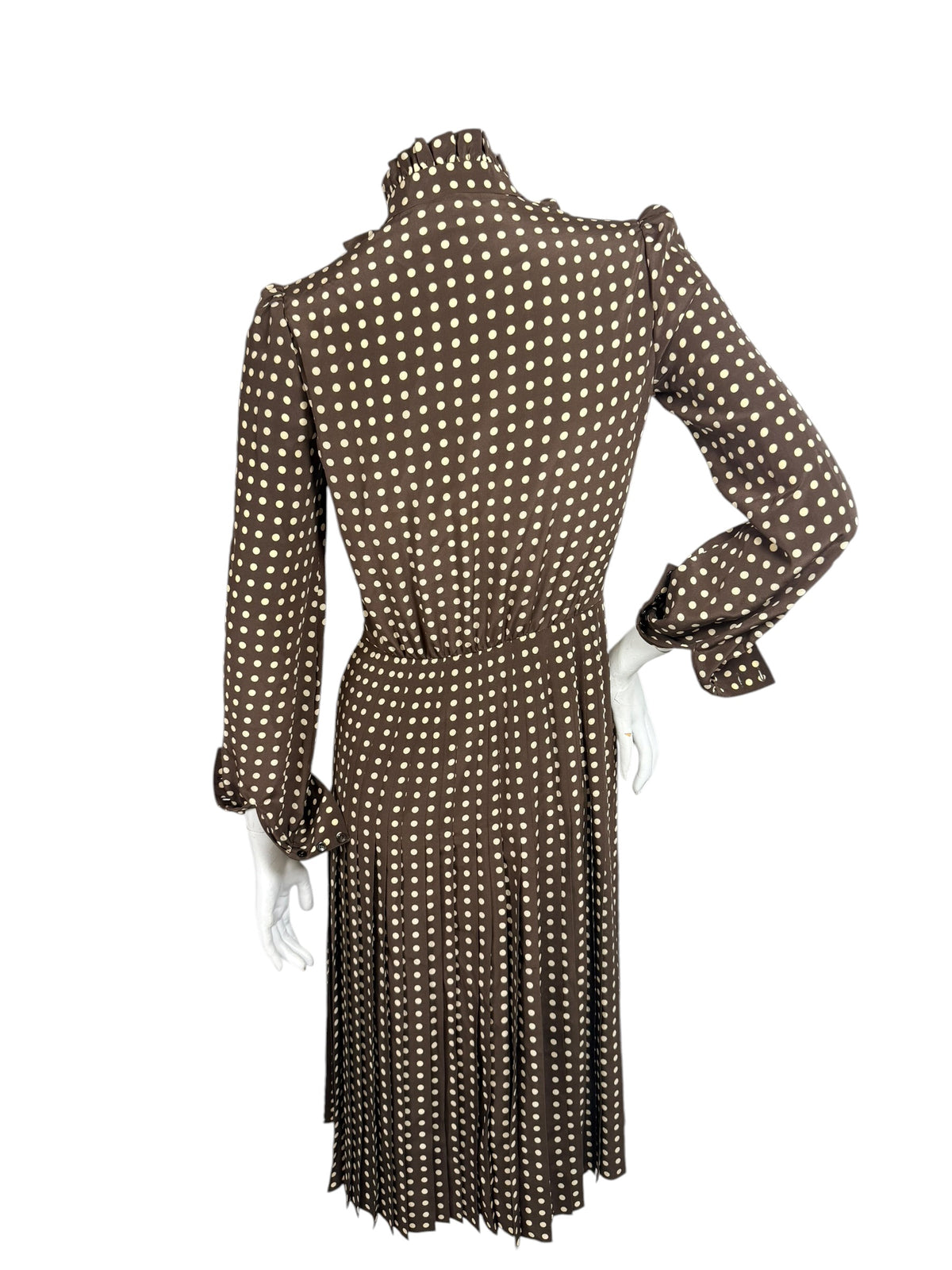 Rear view of Celine Fall 2020 runway polka dot silk midi dress showing gathered waist, long sleeves and finely pleated skirt.