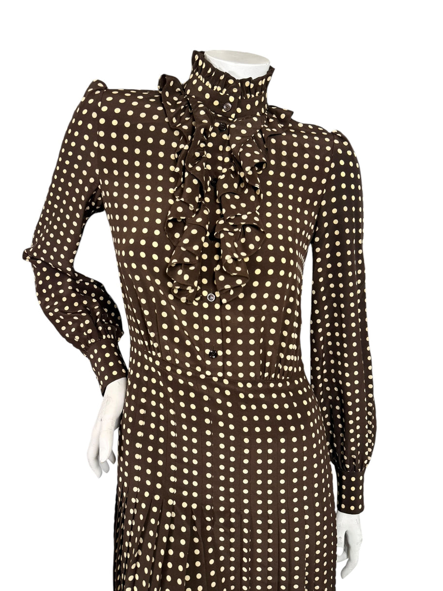 Front bodice detail of Celine Fall 2020 runway silk dress showing high buttoned ruffle collar, cascading front ruffles and polka dot print.