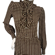 Front bodice detail of Celine Fall 2020 runway silk dress showing high buttoned ruffle collar, cascading front ruffles and polka dot print.