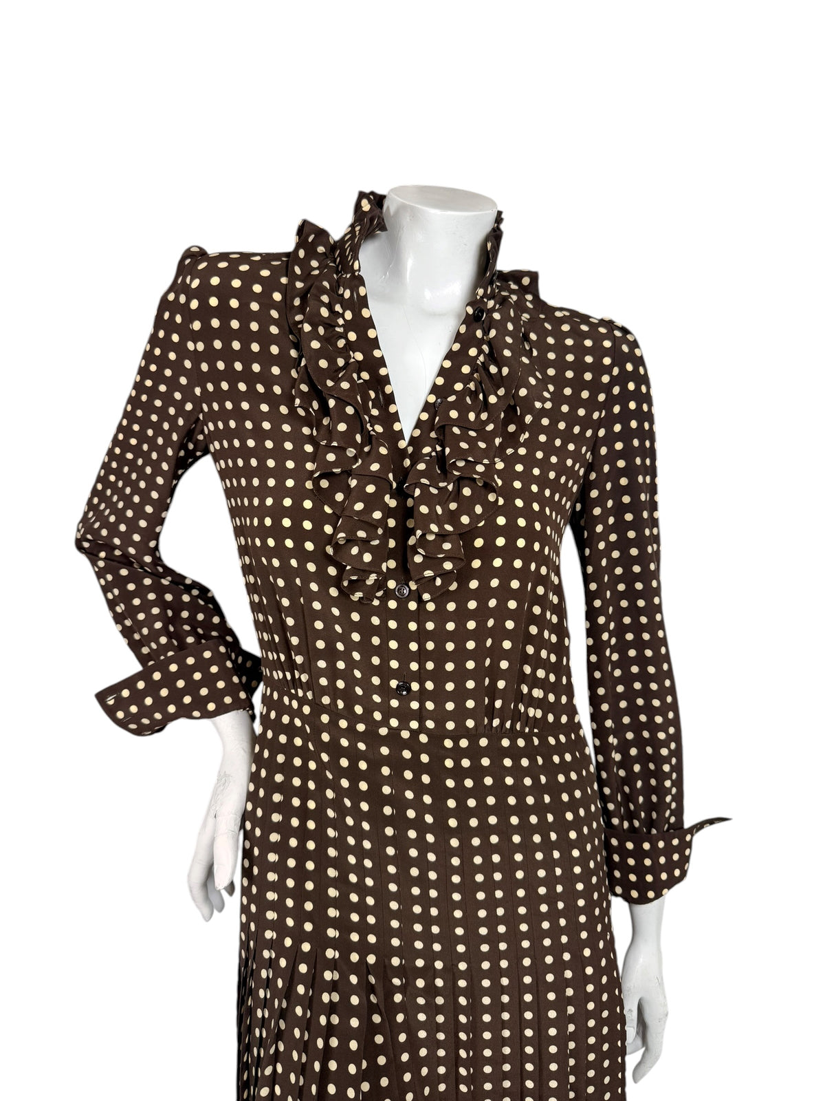 Close-up of Celine FW20 silk dress featuring cascading ruffles, cream polka dots, front buttons and a fitted waist.