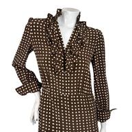 Close-up of Celine FW20 silk dress featuring cascading ruffles, cream polka dots, front buttons and a fitted waist.