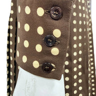 Close-up of the three-button sleeve cuff on Celine FW20 chocolate brown silk dress with cream polka dot print.