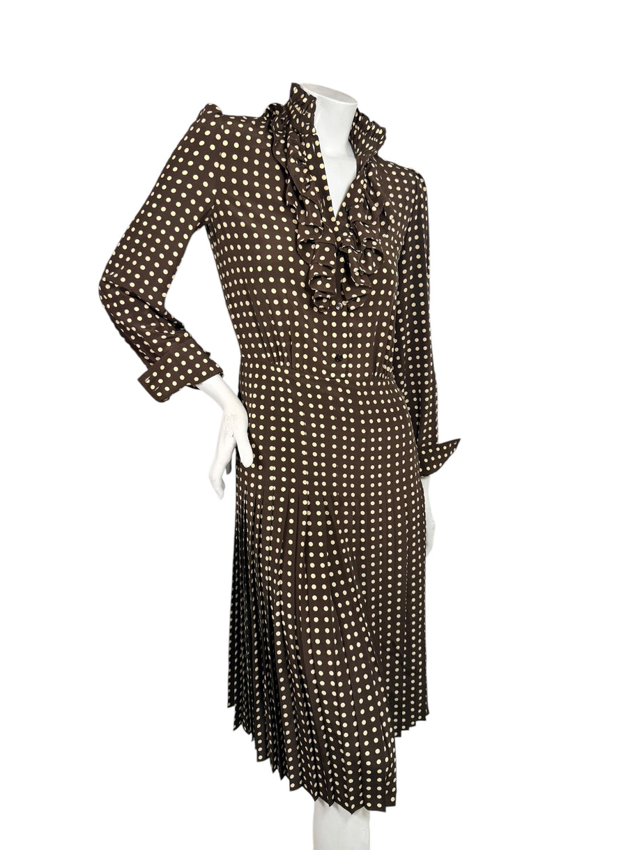 Full-length front view of Celine Fall 2020 Look 15 silk dress with open ruffled neckline, fitted waist and flowing pleated polka dot skirt.
