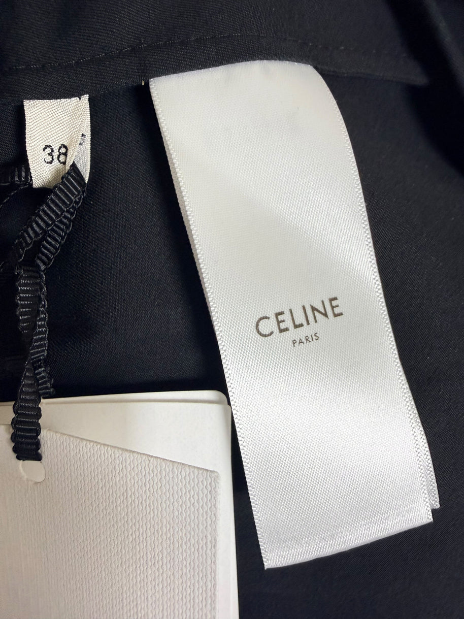 Close-up of Celine Paris woven designer label and French size 38 tag inside black cotton belted midi skirt with original retail tags attached.