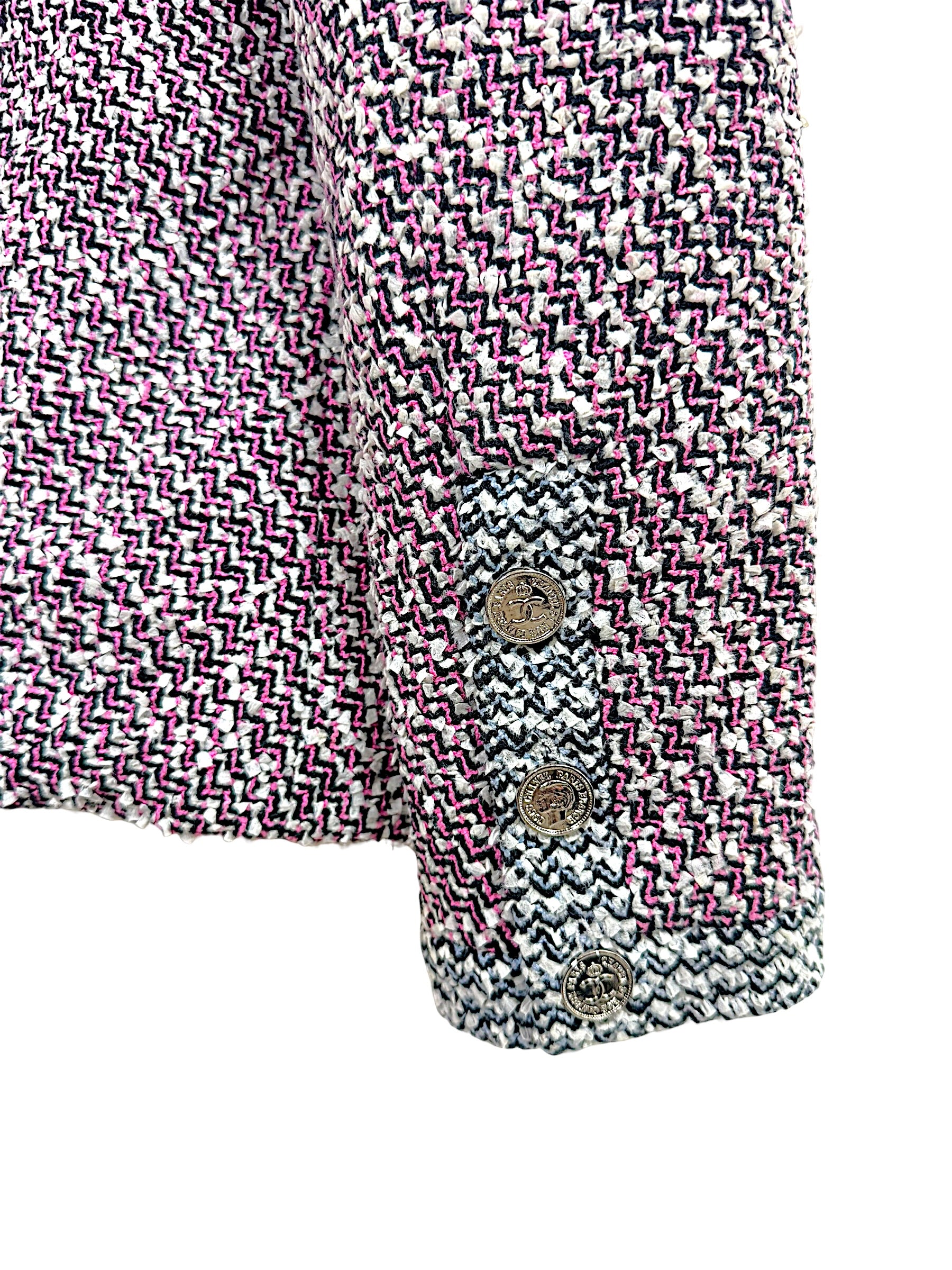 Close-up of Chanel Spring 1996 tweed jacket cuff with signature CC embossed buttons and contrast woven trim