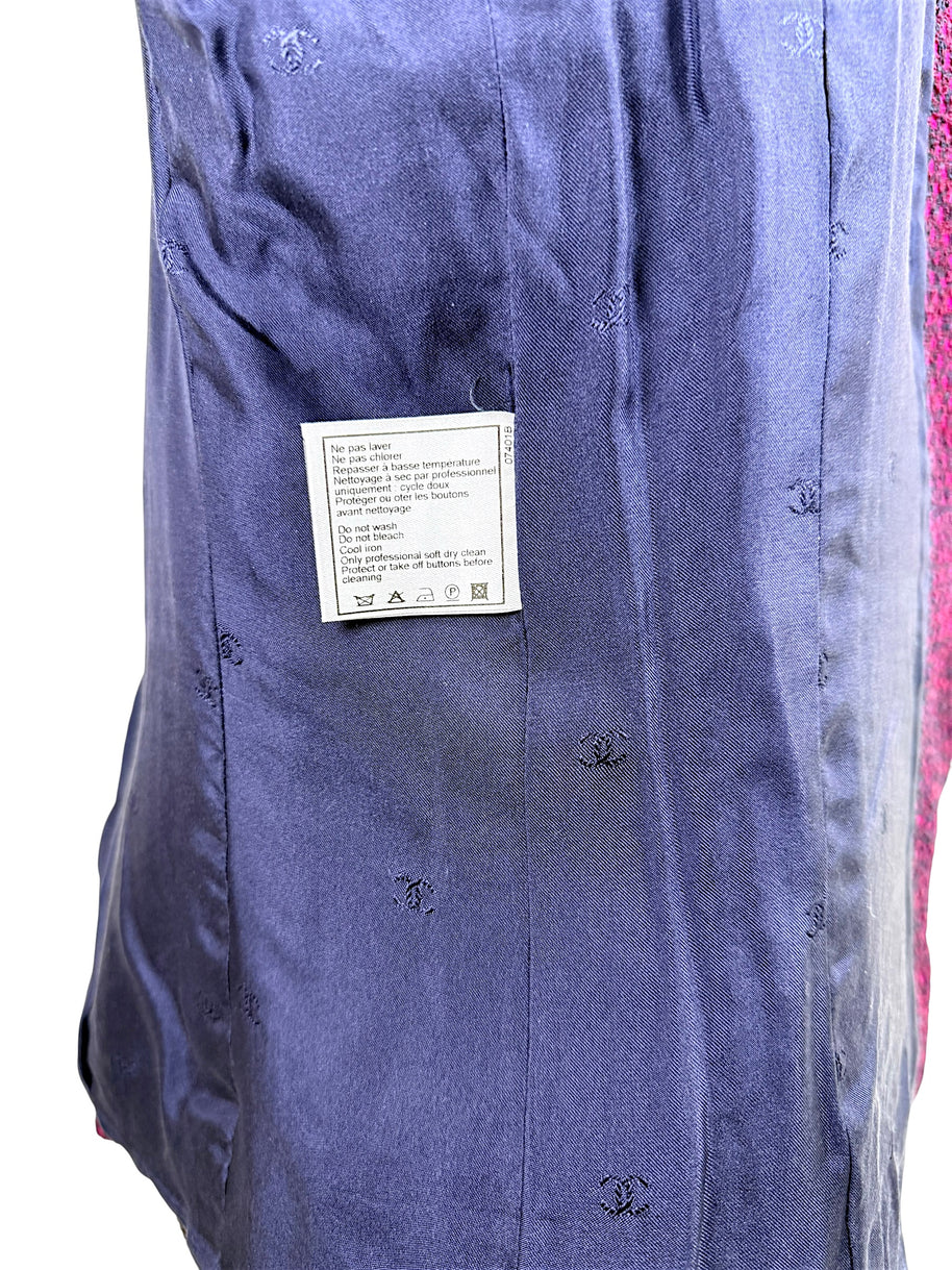 Interior navy silk CC monogram lining of Chanel 1998 tweed jacket with attached care instruction tag