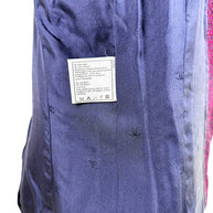 Interior navy silk CC monogram lining of Chanel 1998 tweed jacket with attached care instruction tag
