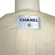 Close-up of Chanel label inside vintage 1998 ivory bouclé tweed jacket lining