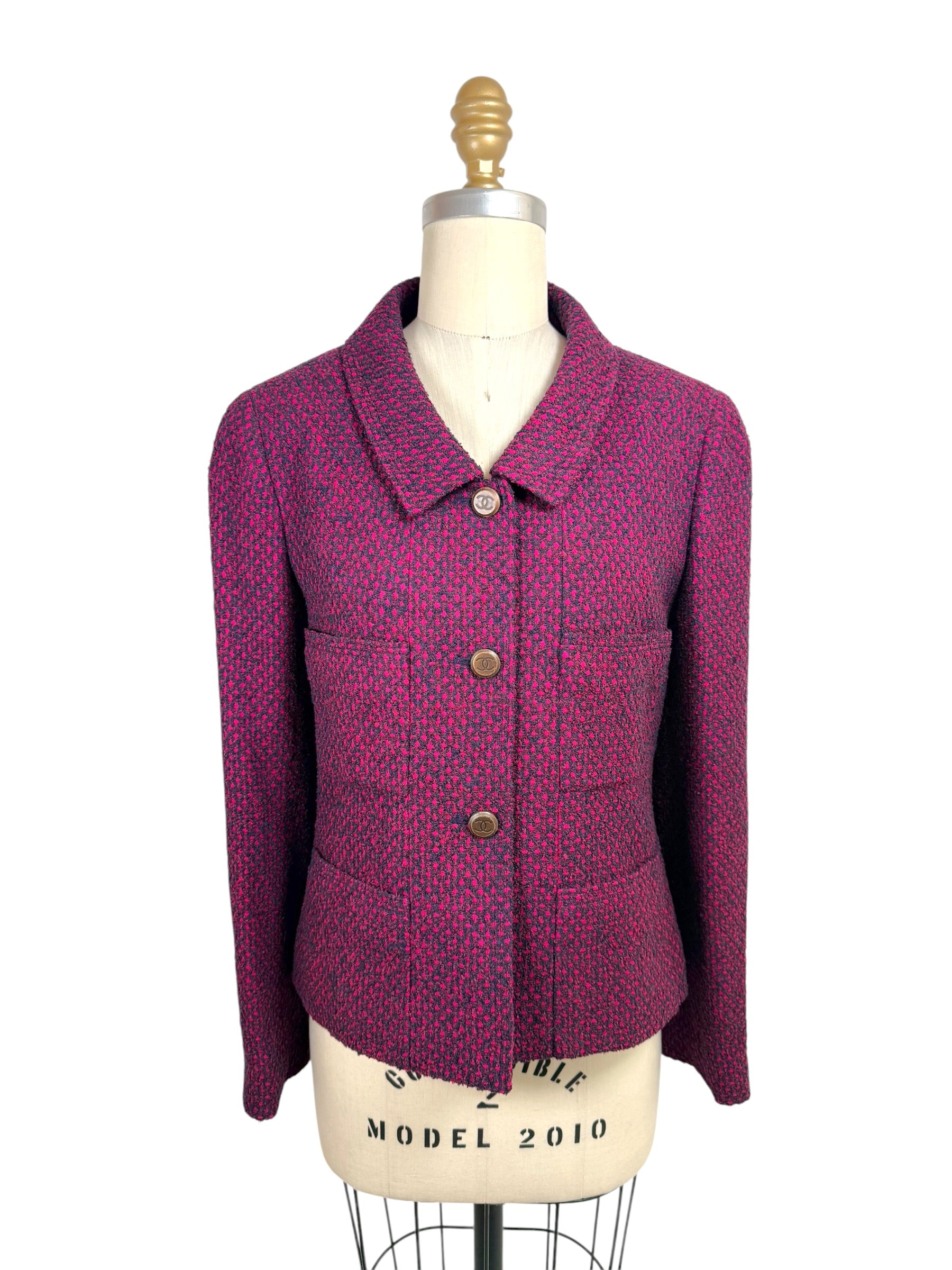 Vintage Chanel 1998 fuchsia and navy tweed jacket front view with CC logo buttons and pointed collar on mannequin