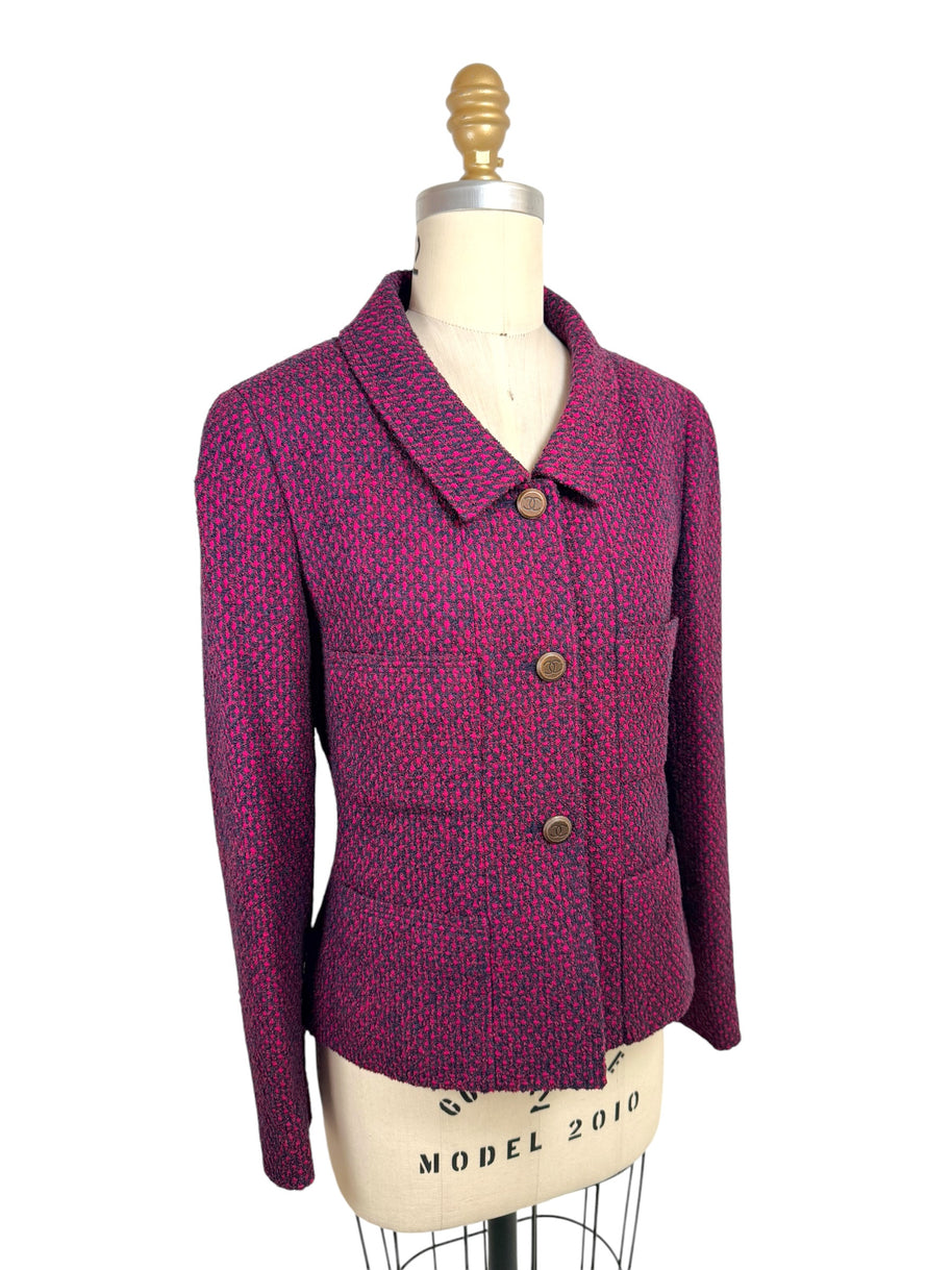 Three-quarter front view of vintage Chanel 1998 pink and navy tweed jacket with structured tailoring