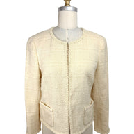 Vintage 1998 Chanel ivory bouclé tweed jacket front view with fringe trim and patch pockets on mannequin
