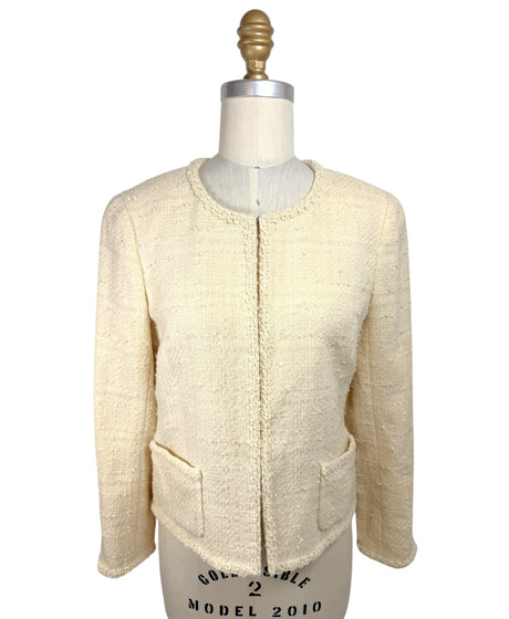 Vintage 1998 Chanel ivory bouclé tweed jacket front view with fringe trim and patch pockets on mannequin