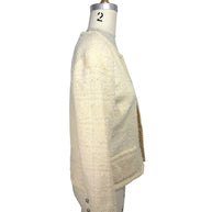 Side profile of vintage Chanel ivory bouclé tweed jacket with textured fabric and cropped silhouette