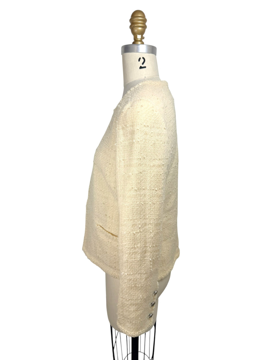 Right side view of vintage Chanel ivory bouclé jacket with structured tailoring and cropped fit
