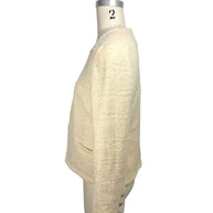 Right side view of vintage Chanel ivory bouclé jacket with structured tailoring and cropped fit