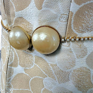 Chanel runway vest pearl belt close up showing light wear on oversized pearls