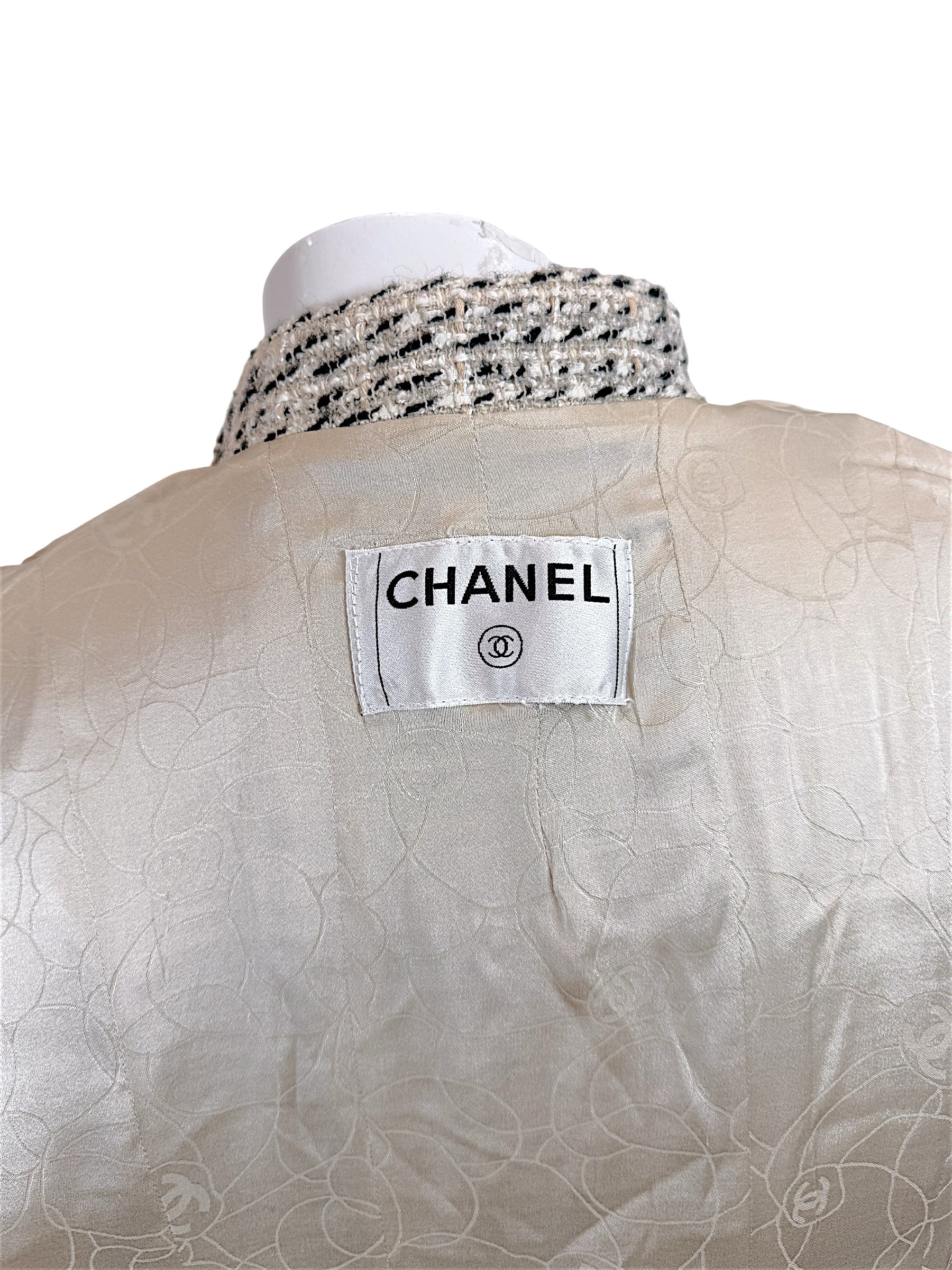 Close-up of Chanel label and silk camellia jacquard lining inside vintage 2004 Chanel tweed jacket