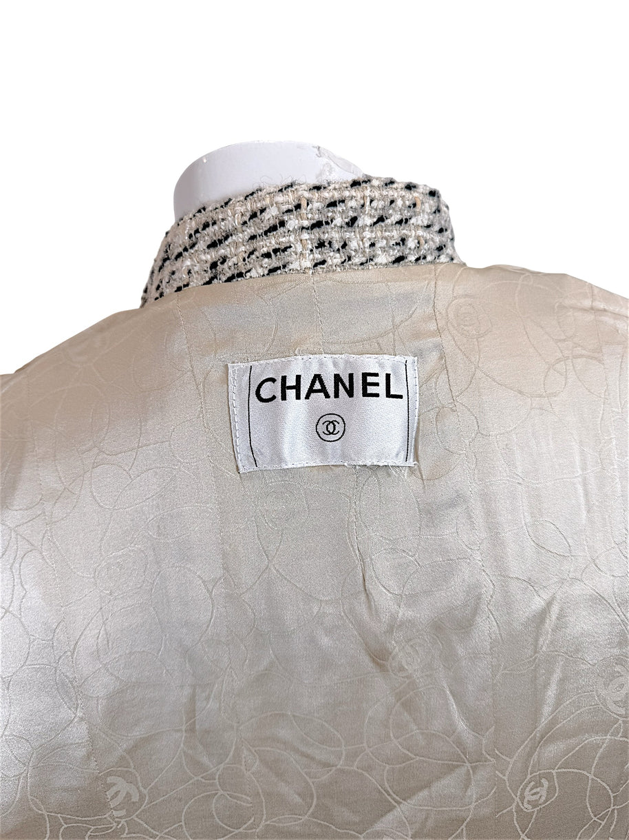 Close-up of Chanel label and silk camellia jacquard lining inside vintage 2004 Chanel tweed jacket