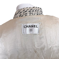 Close-up of Chanel label and silk camellia jacquard lining inside vintage 2004 Chanel tweed jacket